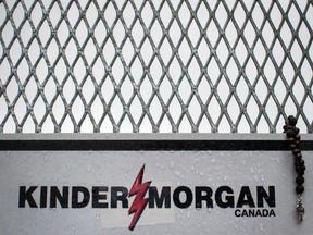 Rosary beads are seen on a gate at Kinder Morgan's facility in Burnaby, B.C., as religious leaders and more than 100 members of diverse faith communities participate in a protest against the company's expansion of the Trans Mountain Pipeline, on Saturday April 28, 2018.