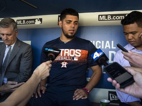 Houston Astros relief pitcher Roberto Osuna is interviewed in the dugout before a baseball game against the Los Angeles Dodgers in Los Angeles, Sunday, Aug. 5, 2018. Osuna served a 75-game suspension for violating Major League Baseball's domestic violence policy.