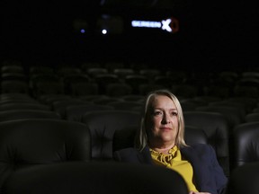 In this photo taken on Thursday, Aug. 9, 2018, Kelly Drew, an operations director at Cineworld, sits in the front row at Cineworld during a demonstration of ScreenX, a technology that projects films onto three screens, in London. Sit at the back of the movie theater, and it's possible to see the appeal of ScreenX, the latest attempt to drag film lovers off the sofa and away from Netflix. Instead of one screen, there are three, creating a 270-degree view meant to add to the immersive experience you can't get from the home TV.