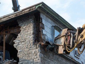 Crews worked to stabilize Magee House after part of a wall fell down.