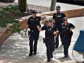 Police investigate the scene of a multiple shooting at the Jacksonville Landing Sunday, Aug. 26, 2018, during a video game competition in Jacksonville, Fla.