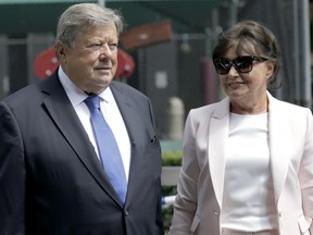 Viktor and Amalija Knavs listen as their attorney makes a statement in New York, Thursday, Aug. 9, 2018. First Lady Melania Trump's parents have been sworn in as U.S. citizens. A lawyer for the Knavs says the Slovenian couple took the citizenship oath on Thursday in New York City. They had been living in the U.S. as permanent residents.