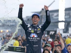 In this July 23, 2017, file photo, Kasey Kahne (5) celebrates winning the NASCAR Brickyard 400 auto race at Indianapolis Motor Speedway in Indianapolis. Kahne says he is retiring from full-time racing. The 38-year-old Kahne announced his intentions Thursday, Aug. 16, 2018, file photo on Twitter, saying "I'm not sure what the future holds for me, but I'm at ease with the decision that I have made.