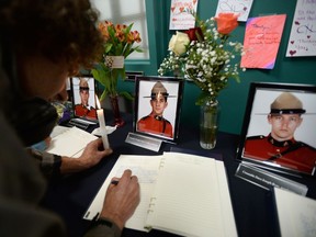 A book of condolence is signed at the Codiac RCMP detachment in Moncton, N.B. on Friday, June 6, 2014 to pay respect to the three RCMP officers who were killed and the two injured in a shooting spree on Wednesday. Justin Bourque, 24, is facing three charges of first-degree murder and two charges of attempted murder.