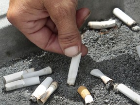 FILE - In this June 22, 2012 file photo, a smoker extinguishes a cigarette in an ash tray in Sacramento, Calif. If you quit smoking and gain weight, it may seem like you're trading one set of health problems for another. But a new U.S. study released on Wednesday, Aug. 15, 2018 finds you're still better off in the long run.