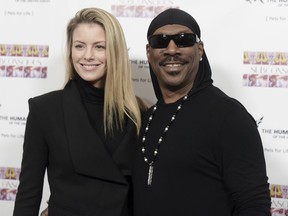 FILE - In this Nov. 20, 2016, file photo, Paige Butcher, left, and Eddie Murphy attend "SUBCONSCIOUS" by Bria Murphy Gallery Opening at Lace Gallery in Los Angeles. Murphy is going to be a father for the tenth time. The actor and comedian's publicist has issued a statement that Murphy and longtime girlfriend Butcher are expecting their second child in December.
