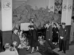 FILE - In this August 1948 file photo, Claire Ruth, center left, flanked by Mr. and Mrs. Richard Flanders, son-in-law and adopted daughter of Babe Ruth, as they pass the casket containing his body in the rotunda of Yankee Stadium in New York. Considered by many to be the greatest player in baseball history, the New York Yankees and Boston Red Sox legend set home run records - 60 in one season, 714 in his career - that stood for decades, and he remains one of the sport's defining figures.(AP Photo, File)