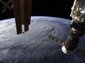 This image provided by NASA on Wednesday, Aug. 22, 2018 shows Hurricane Lane as seen from the International Space Station. The National Weather Service says the hurricane will still pack a wallop for Hawaii on Thursday before gradually slowing over the next two days. Early Wednesday, the hurricane was 320 miles (515 kilometers) south of Hilo on Hawaii Island and moving northwest toward other islands. (NASA via AP)