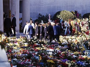 FILE - In this Aug 18, 1977 file photo, pallbearers carry the flower-covered coffin of Elvis Presley into the Forest Hills Cemeteries mausoleum in Memphis, Tenn. After a thief tried to snatch his body, the remains of both Elvis and his mother were moved to a garden at Graceland. (AP Photo, File)