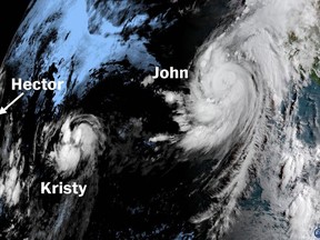 Tropical cyclones Hector, Kristy and John over the Pacific Ocean.