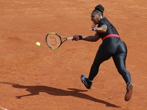 FILE - In this May 29, 2018 file photo, Serena Williams of the U.S. returns a shot against Krystyna Pliskova of the Czech Republic during their first round match of the French Open tennis tournament at the Roland Garros stadium in Paris. Serena Williams will no longer be allowed to wear her sleek, figure-hugging catsuit at the French Open. The French Tennis Federation president, Bernard Giudicelli, says the tournament that Williams has won three times is introducing a dress code to regulate players' uniforms because "I think that sometimes, we've gone too far."