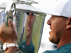 Brooks Koepka holds the Wanamaker Trophy after he won the PGA Championship golf tournament at Bellerive Country Club, Sunday, Aug. 12, 2018, in St. Louis.