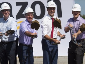 Prime Minister Justin Trudeau, second right, Ottawa Mayor Jim Watson, left, Amazon Ddrector of operations Canada Glenn Sommerville, second left, and vice president of Amazon Canada Alexandre Gagnon, right, participate in the ground breaking ceremony.