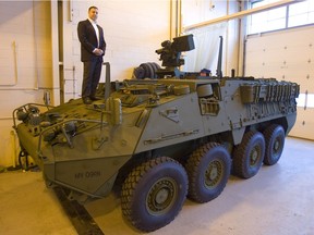 Danny Deep of General Dynamics Land Systems stands on one of their Stryker light armoured vehicles at their London Ontario plant Monday March 21, 2011.
