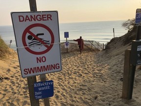 Steve McFadden, 49, of Plattsburgh, N.Y., gazes at Long Nook Beach in Truro, Mass., on Thursday, Aug. 16, 2018. Authorities closed the Cape Cod beach to swimmers after a man was attacked by a shark on Wednesday -- the first attack on a person in Massachusetts since 2012. The unidentified victim survived the attack and was airlifted to a Boston hospital.