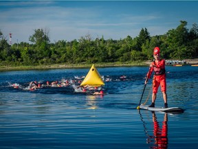 A Riverkeeper paddler guides participants in the Riverkeeper 4K swim Saturday Aug. 11, 2018.