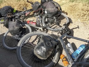 In this photo taken on Sunday, July 29, 2018, bikes are left where four tourists were killed when a car rammed into a group of foreigners on bicycles south of the capital of Dushanbe, Tajikistan.