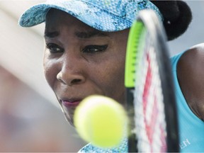 Venus Williams returns to Caroline Dolehide during their first-round match in Montreal on Monday.