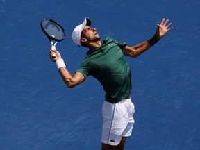 In this Aug. 7 file photo, Novak Djokovic serves to Mirza Basic at the Rogers Cup.