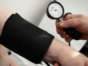 A doctor measures blood pressure.