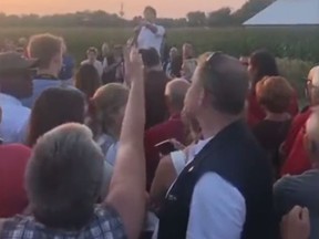 A woman heckles Prime Minister Justin Trudeau about immigration at an event in Sabrevois, Que., on Aug. 16, 2018.