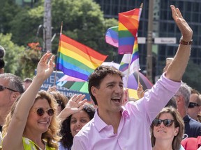 Prime minister Justin Trudeau and his wife Sophie Gregoire Trudeau march in the pride parade in Montreal on Sunday, August 19, 2018.