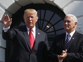 U.S. President Donald Trump, left, with Vice-President Mike Pence, waves after speaking about the economy from the South Lawn of the White House in Washington, July 27, 2018.