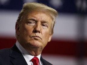 President Donald Trump listens during a campaign rally at Florida State Fairgrounds Expo Hall, Tuesday, July 31, 2018, in Tampa, Fla. (AP Photo/Evan Vucci)