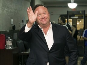 FILE - In this April 19, 2017, file photo, Alex Jones, a right-wing radio host and conspiracy theorist, arrives at the courthouse in Austin, Texas. Twitter says it is suspending the account of the far-right conspiracy theorist Alex Jones for one week after he violated the company's rules against inciting violence.