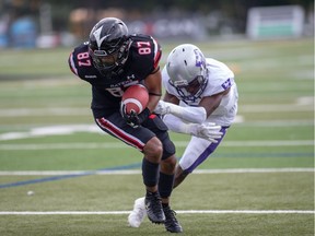 Ravens receiver Chad Manchulenko (87) tries to pull away from a Mustangs tackler during Sunday's game at Carleton's MNP Park. Valerie Wutti/Carleton Ravens