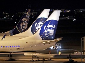 Alaska Airlines planes sit on the tarmac at Sea-Tac International Airport Friday evening, Aug. 10, 2018, in SeaTac, Wash. An airline mechanic stole an Alaska Airlines plane without any passengers and took off from Sea-Tac International Airport in Washington state on Friday night before crashing near Ketron Island, officials said.
