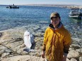 Albert Netser tweeted this picture of his 16-year-old son Nangaat standing on a rock in Rankin Inlet, Nunavut with his first harvested beluga whale on Monday in this handout photo. Netser says he didn't expect to be at the brunt of controversy.