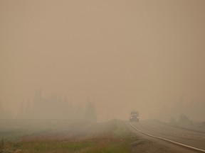 Thick smoke from wildfires fills the air as a motorist travels on Hwy. 27 between Vanderhoof and Fort St. James, B.C.,
