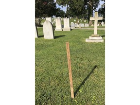 A wooden spike marks the spot, Saturday, Aug. 26, 2018, where Sen. John McCain, R-Ariz. will be buried on the grounds of the U. S. Naval Academy in Annapolis, Md. McCain is set to be buried next to his best friend, Adm. Chuck Larson, from his days at the U.S. Naval Academy _ and not in Arlington National Cemetery with his father and grandfather.