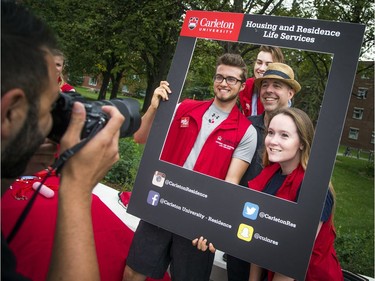 Carleton's new president, Benoit-Antoine Bacon, posed for a photo with students during move-in day.