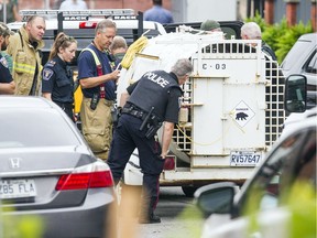 Police check out the ByWard Bear captured after a walkabout Sept. 6