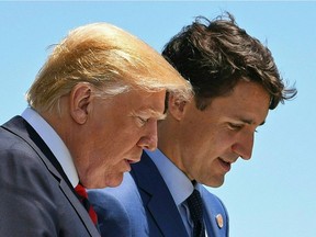 US President Donald Trump (L) speaks with Canadian Prime Minister Justin Trudeau during the G7 Summit in La Malbaie, Quebec, Canada, June 8, 2018.