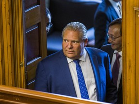 Ontario Premier Doug Ford looks into the chamber during an interruption by hecklers during the morning session in the legislature at Queen's Park in Toronto, Ont. on Wednesday September 12, 2018.