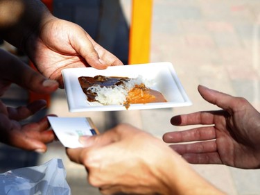 People try samples from the Guru's Inspired restaurant at the Taste of Wellington West event on Saturday.   Patrick Doyle/Postmedia