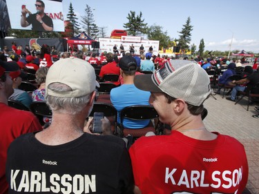 Erik Karlsson fans Ron Kok, left, and Jordan Curry watch the "press conference" at the Ottawa Senators Fan Fest at Canadian Tire Centre in Ottawa on Sunday, September 16, 2018.