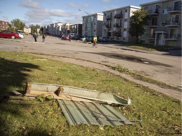 People walk along Rue Georges-Bilodeau in the the Mont-Bleu community in Gatineau, which is in clean-up mode Saturday, September 22, 2018 after a tornado touched down late Friday.