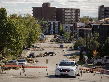 An Gatineau Police car is stationed at the corner of Rue Jumonville and Rue Charles-Albanel, in the Mont-Bleu community in Gatineau, which is in clean-up mode Saturday, September 22, 2018 after a tornado touched down late Friday.