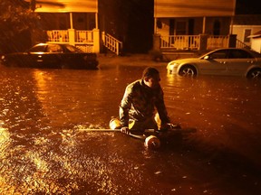 Michael Nelson floats in a boat made from a metal tub and fishing floats after the Neuse River went over its banks and flooded his street during Hurricane Florence September 13, 2018 in New Bern, North Carolina. C