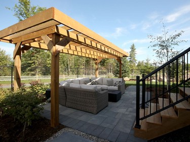 The fully landscaped backyard takes advantage of the fact the home backs onto the Feedmill Creek conservation area, with a generous deck off the main floor and a lower sitting area softened with a pergola. Julie Oliver/Postmedia