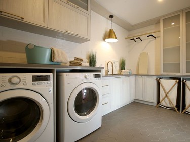The generous laundry room is located near the children's rooms for convenience and comes with plenty of storage and work space, plus room for drip-dry clothing. Julie Oliver/Postmedia