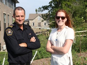 Jake Gravelle, left, and Leslie Collins of the City of Ottawa in front of a house that has the heritage designation in Kanata.   Photo by Jean Levac/Postmedia   129873