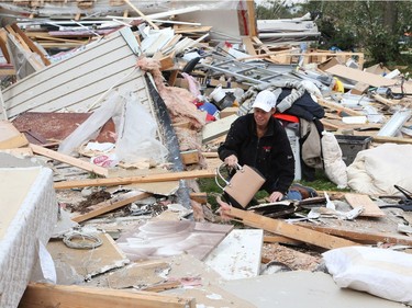 Nicole Lowden finds her purse as she combs through the wreckage of her home on Thomas Dolan Parkway in Dunrobin, September 23, 2018. A tornado left parts of Ottawa and Gatineau devastated.   Photo by Jean Levac/Postmedia   130048