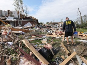Brian Lowden combs through the wreckage of her home on Thomas Dolan Parkway in Dunrobin.