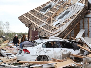 Nicole Lowden combs through the wreckage of her home on Thomas Dolan Parkway in Dunrobin, September 23, 2018. A tornado left parts of Ottawa and Gatineau devastated.   Photo by Jean Levac/Postmedia   130048