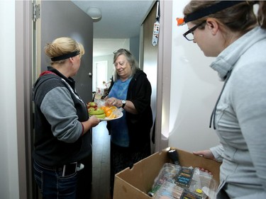 Tthe pair give out muffins and fruit on Monday morning at a Nepean seniors' residence still without power. Amy McConnell (right), along with Pierrette Raymond and countless others, marshalled an army of volunteers through social media and jumped into action to help seniors in the Ottawa stranded without power from the tornado.  For the past four days dozens of them spread out to affected high rises and humped food and water up countless flights of stairs. offering comfort to many seniors left in the dark.